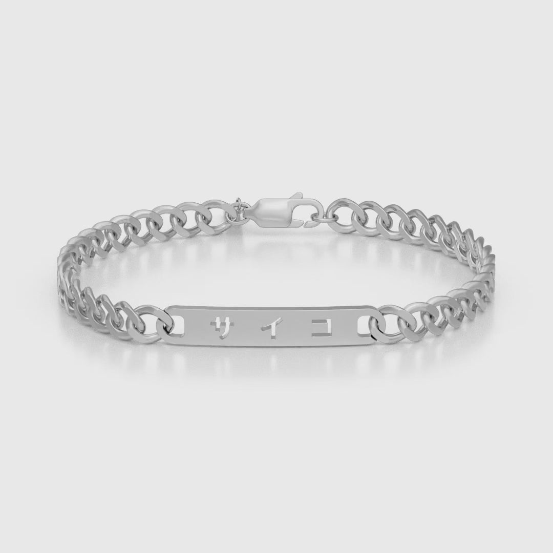 Silver stainless steel 316L cuban chain bracelet with Japanese SAIKO logo cut through the pendant placed on the ground rotating 360 degrees with a white background