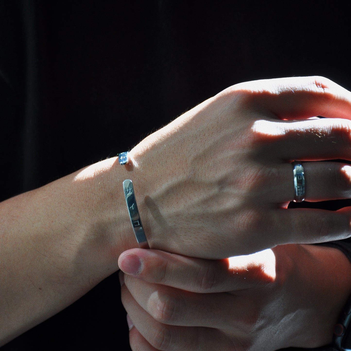 male man boy wearing silver cuff bracelet made from 316L polished stainless steel with japanese character logo engraved onto the signet and ring