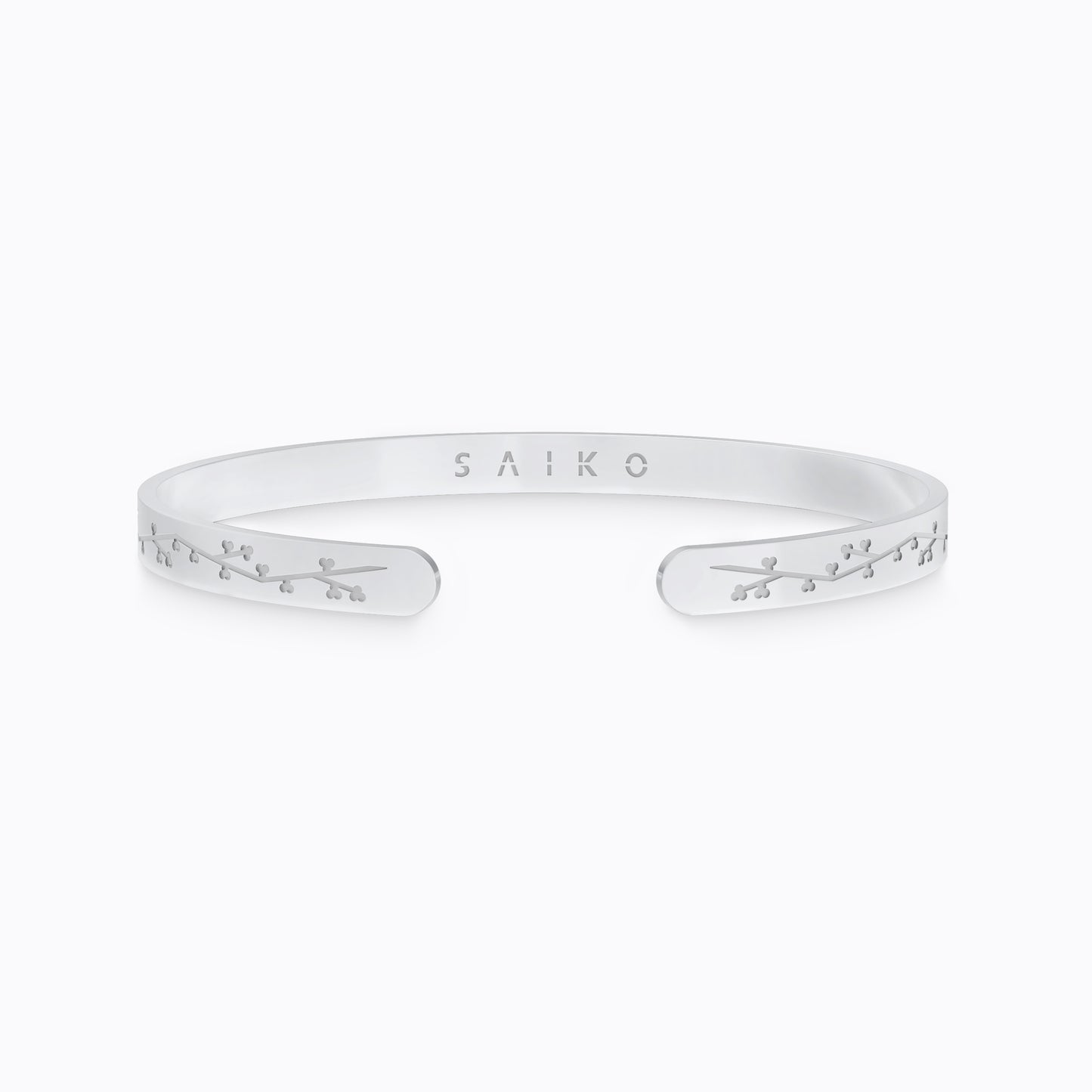 Silver stainless steel 316L cuff bracelet bangle with cherry blossom engraving placed on the ground with a white background